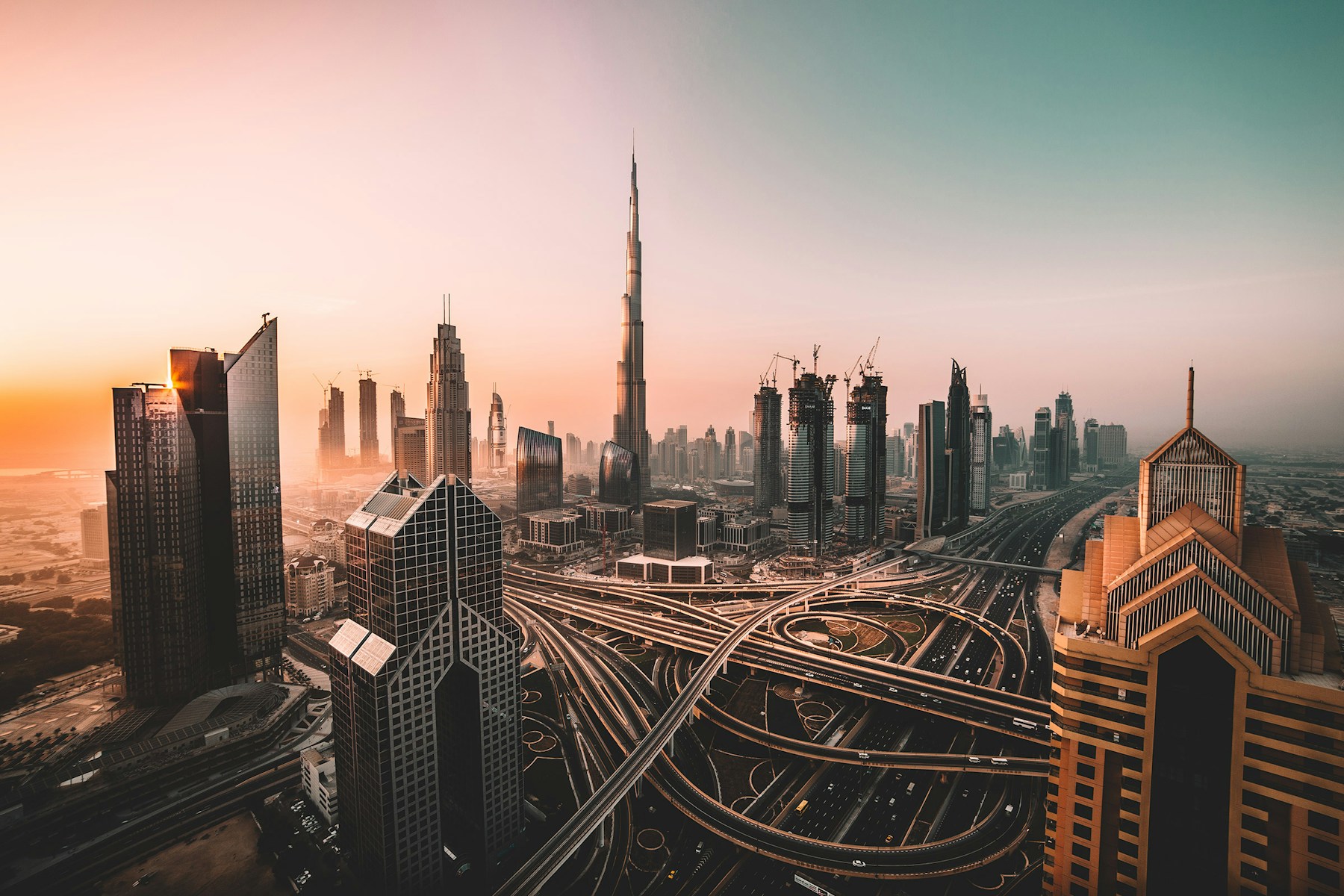 Dubai skyline and Burj Khalifa viewed from above at sunset
